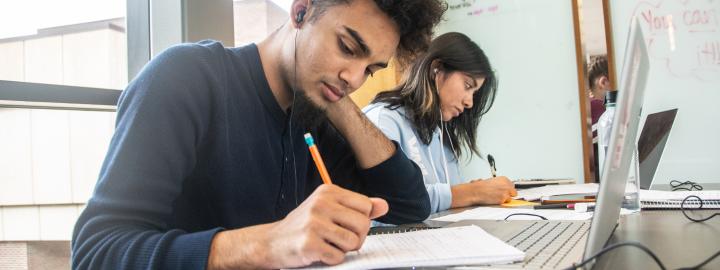 Student studying his class notes.