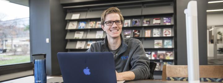 Student studying on his laptop.