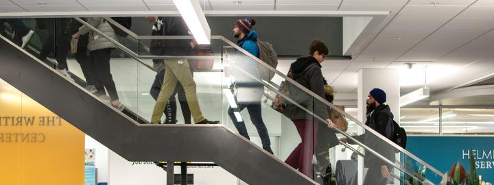 Students ascending and descending central library stairwell