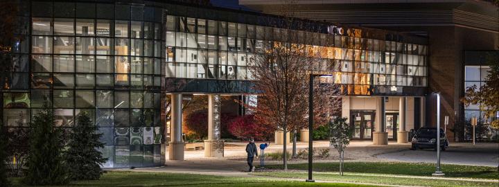 Helmke Library and the skybridge fully lit up at night.