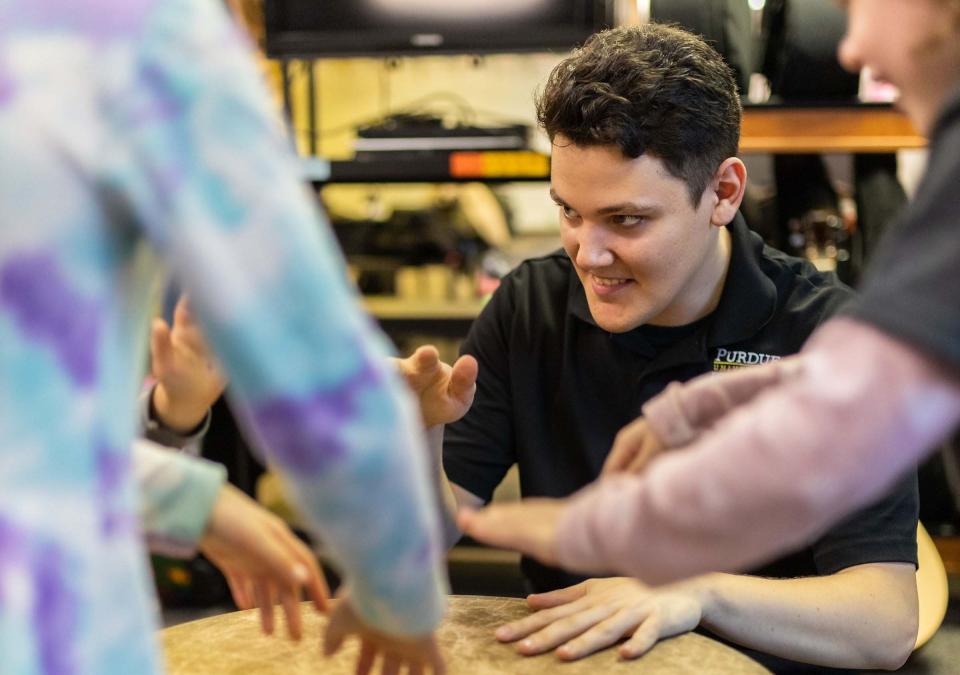 Trevor Perkins, a music therapy undergrad at Purdue Fort Wayne, leads improvisation with a gathering drum.