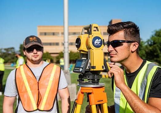 Students from the School of Polytechnic use surveying equipment on the Science Mall.