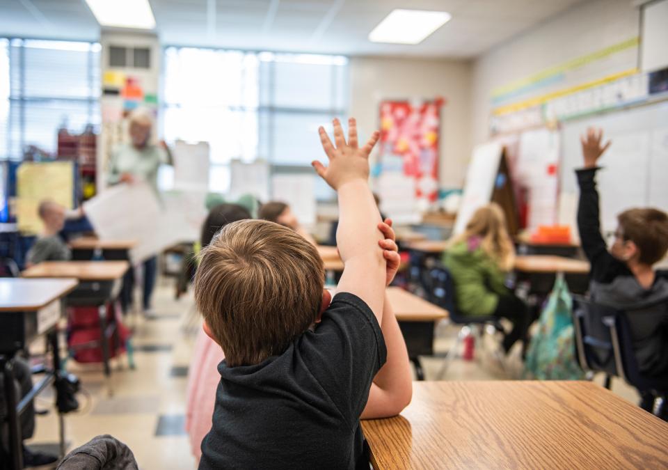 Student raises hand in a student teaching classroom.