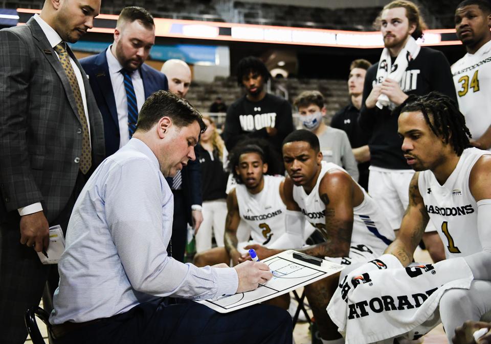 Coach Jon Coffman plans the next possession during a timeout.