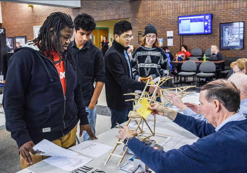 Judges and students at the bridge building competition