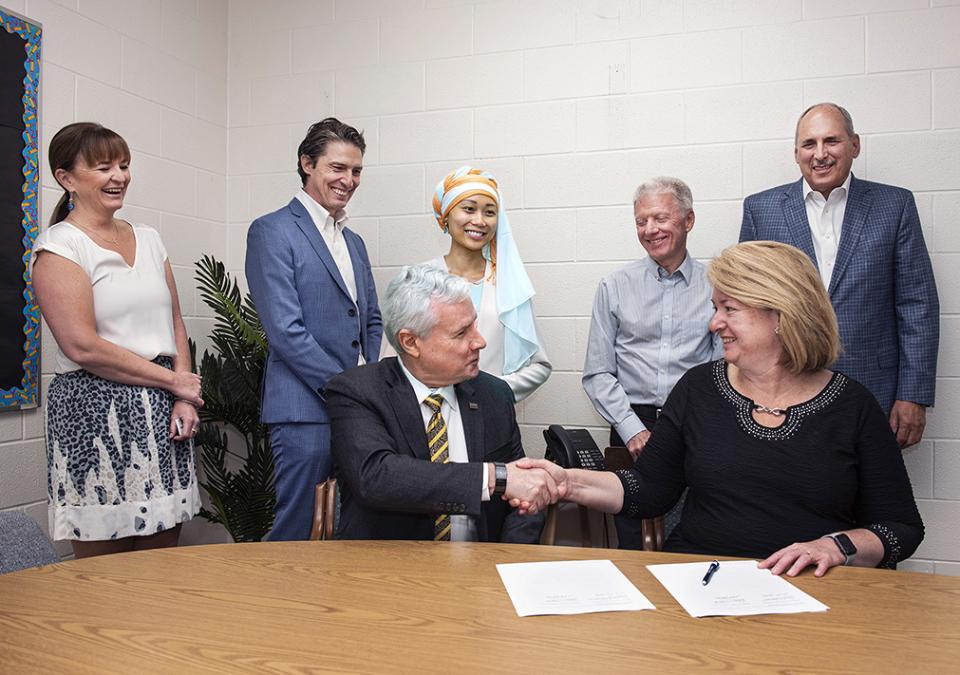 Representatives from Purdue Fort Wayne and Timothy J. Johnson Academy sign a memorandum of understanding.