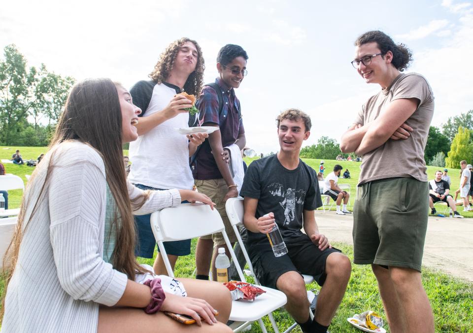 Students in a group enjoying food during Campus Kickoff.