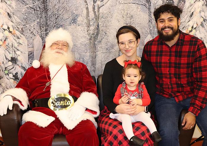 A family visits with Santa Claus at the Adopt-a-Don Jingle Jubilee dinner