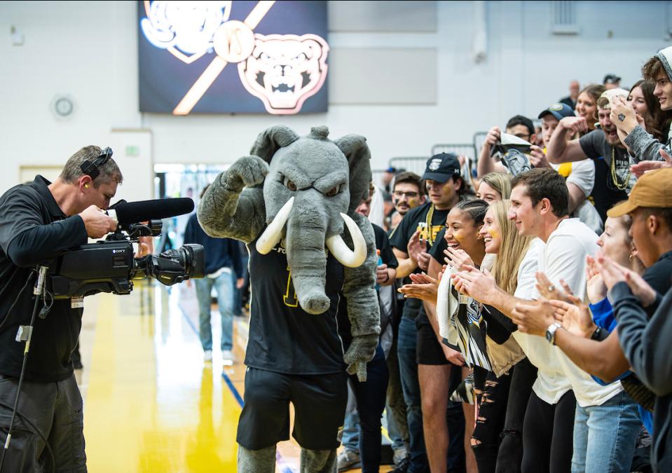 Don flexes his muscles in front of an ESPNU camera