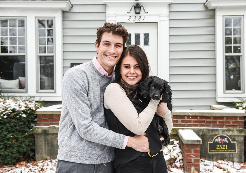 Julia Green and her husband are standing in front of their home