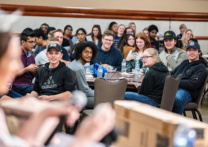 Students are playing bingo in a ballroom.