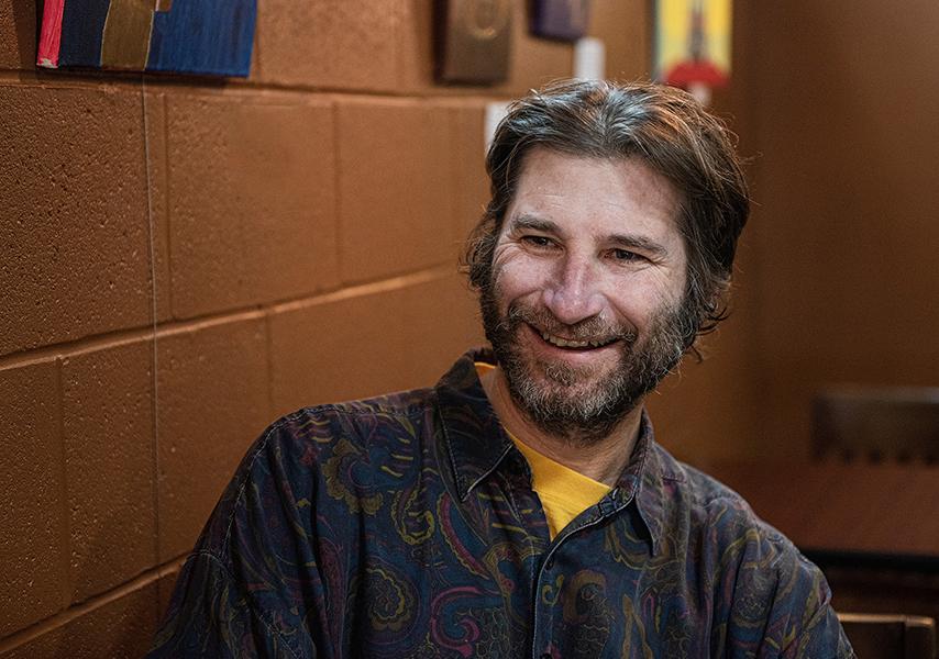 Professor David Schuster is sitting in a coffee house.