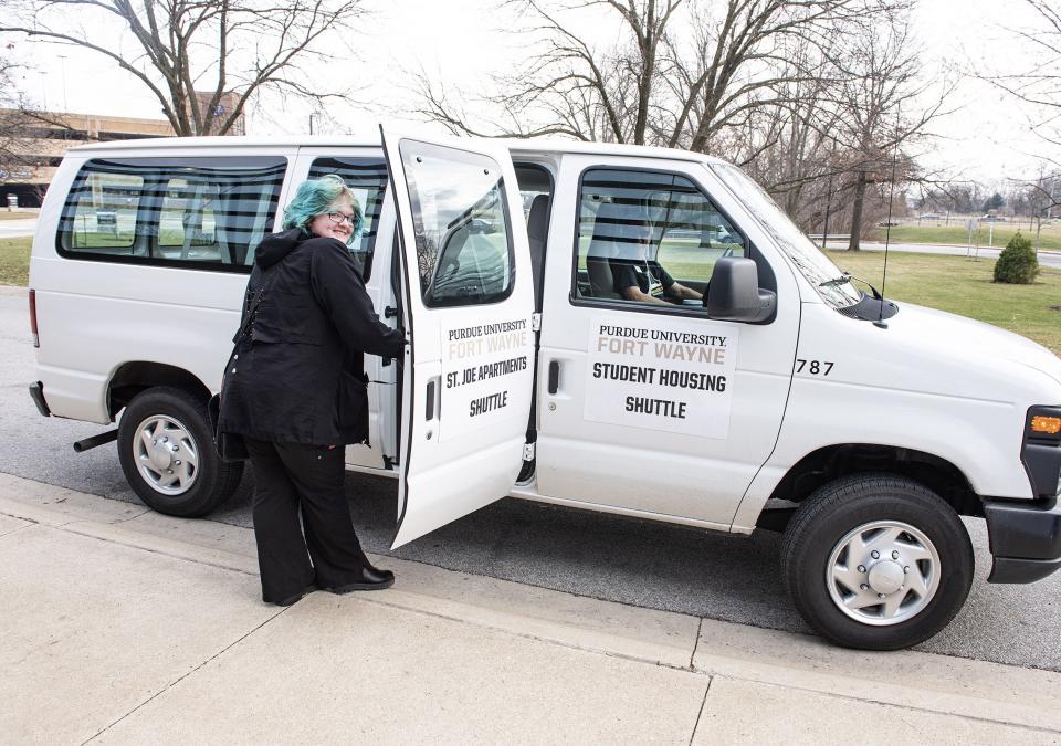 A student is entering a shuttle van at Purdue Fort Wayne