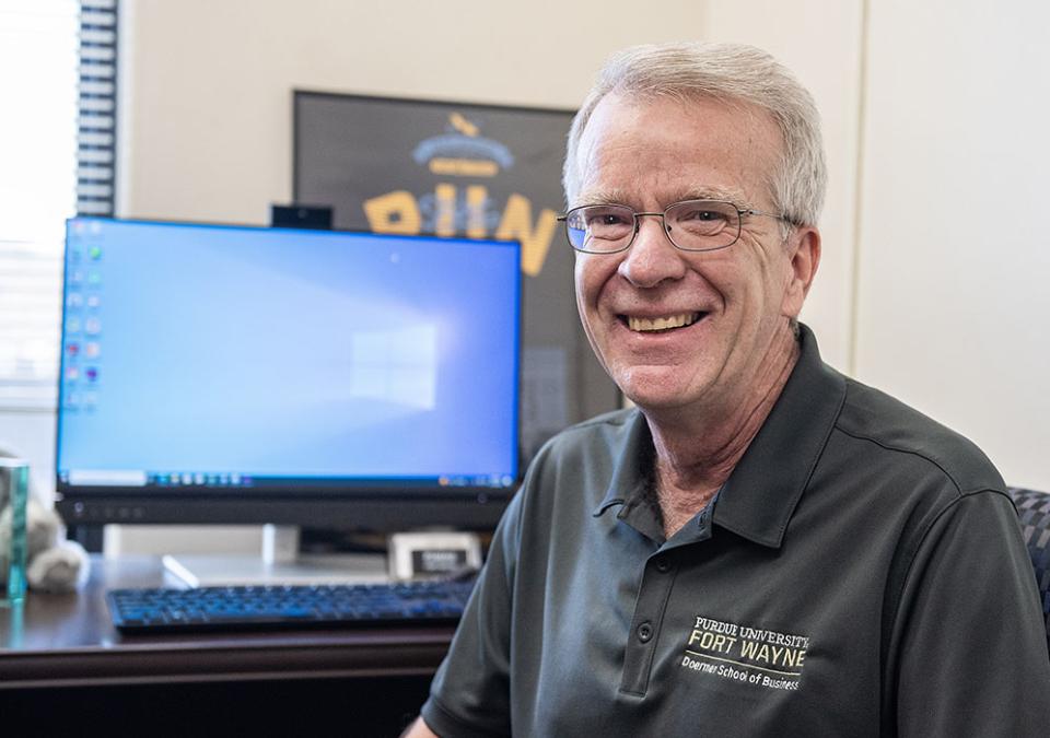 Mike Slaubaugh is sitting in front of his computer