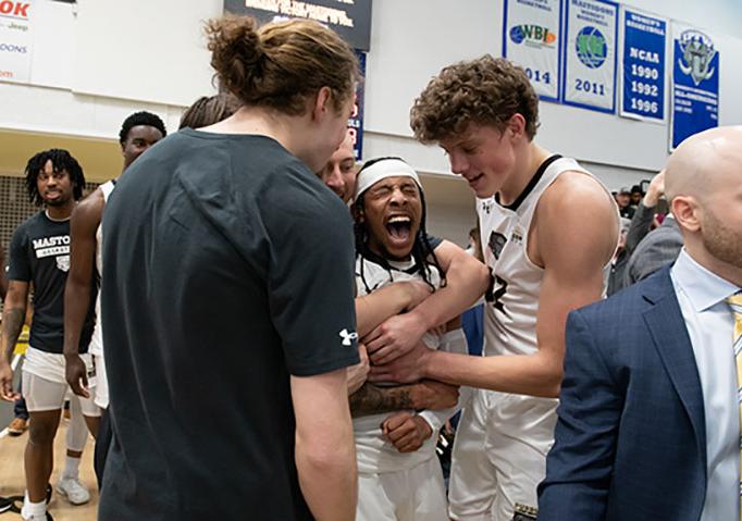 Teammates congratulate Damian Chong Qui after his game-winning shot