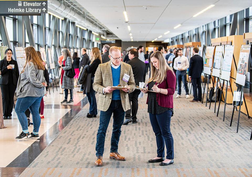 Judges compare notes at the Student Research and Creative Endeavor Symposium