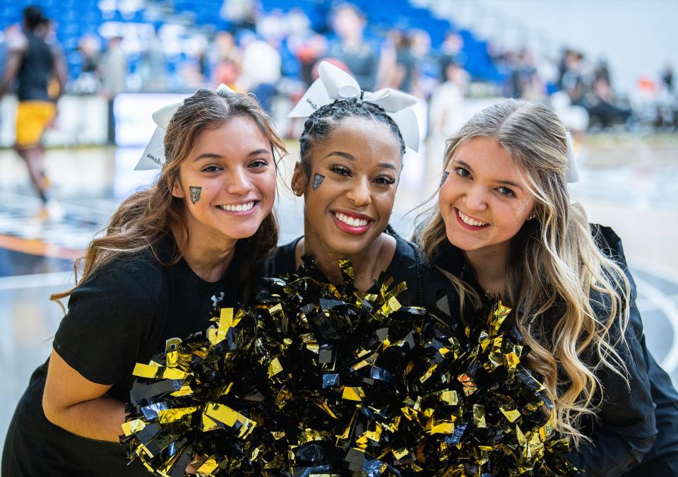 Three PFW cheerleaders are smiling