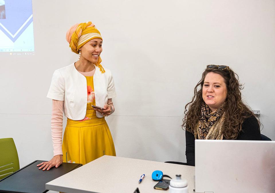 Mary Encabo-Bischoff and Erin McCarthy in a classroom seetting.