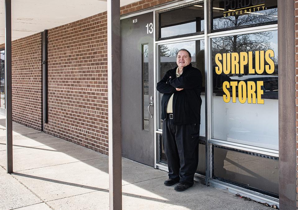 Marcus Tulley is standing next to the Surplus Store entrance