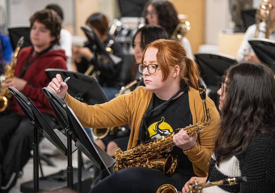 Music education student Lizi Brumbaugh teaches a middle school saxophone player