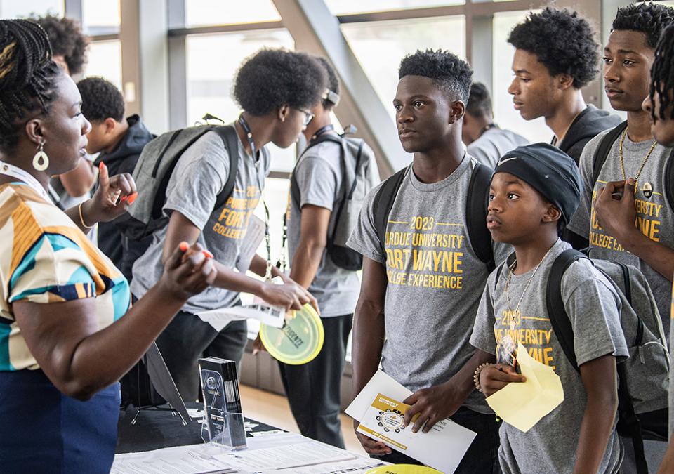 Young participants of the College Experience gather information at the end of a day of workshops