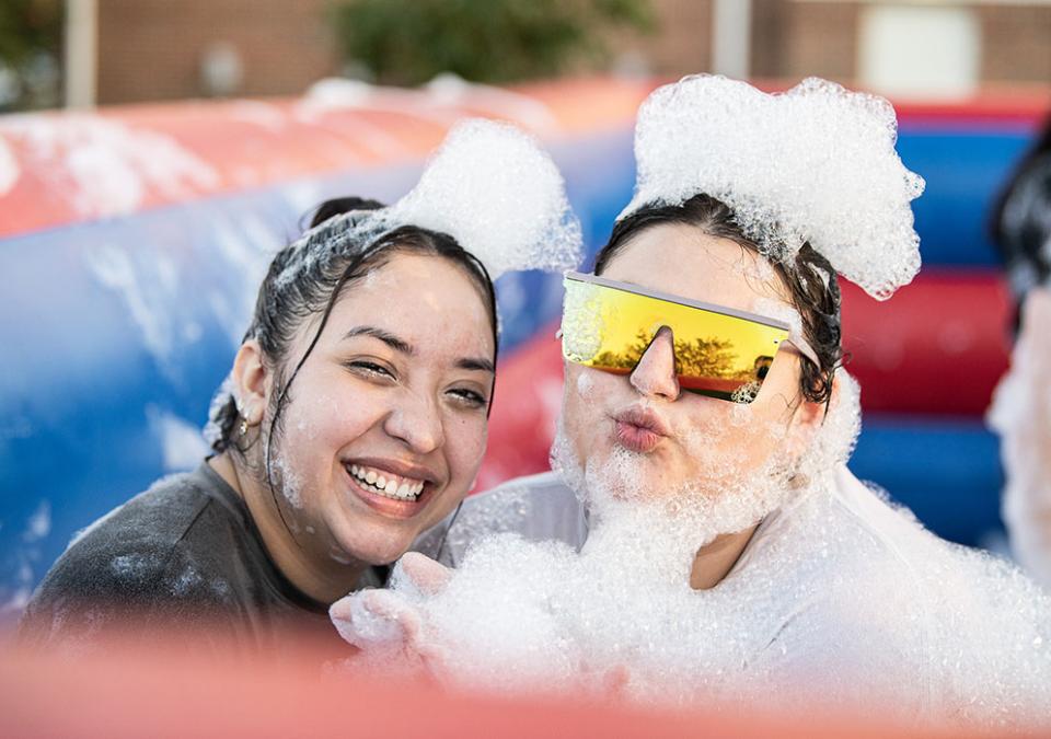 Two students are covered in foam