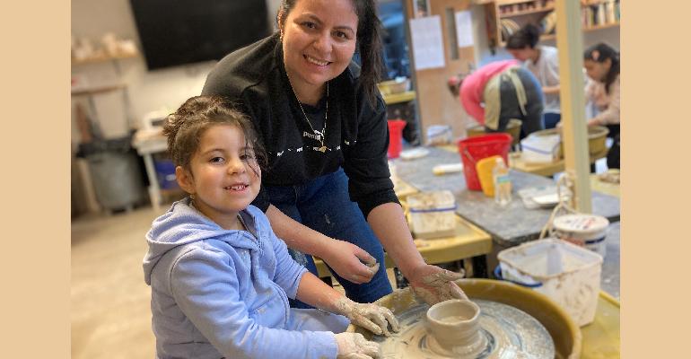 mother and daughter making pottery