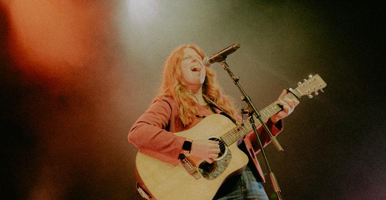 woman singing with guitar