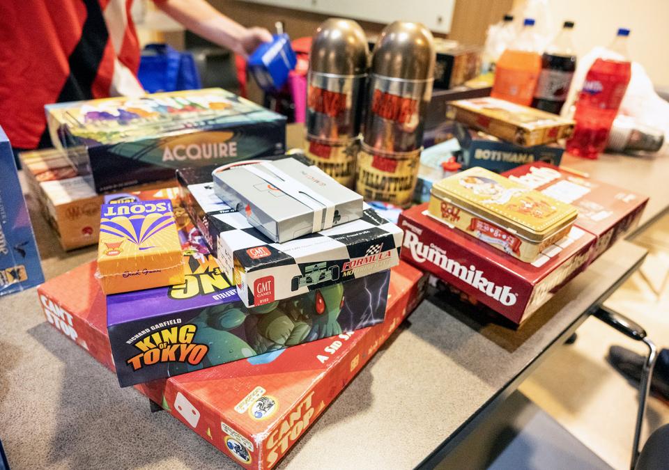 A table piled with board games.