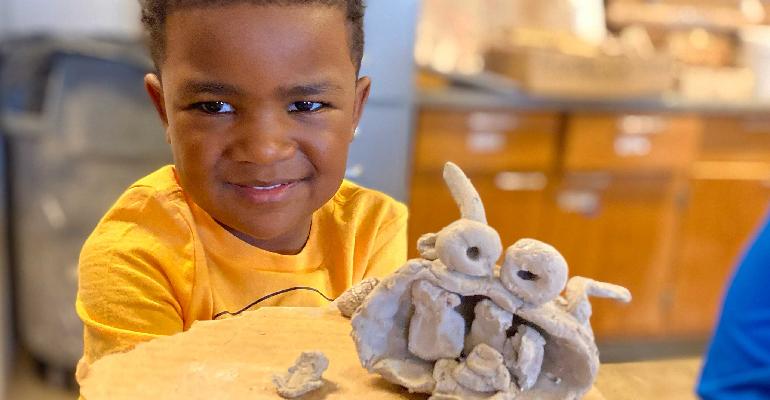 young child with clay