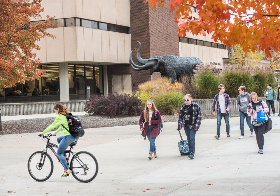 Students on the Alumni Plaza near the mastodon statue