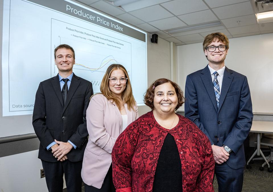 Carson Morton, Pia Briz, Heather Tierney, associate professor of economics, and Josh Fairchild. 