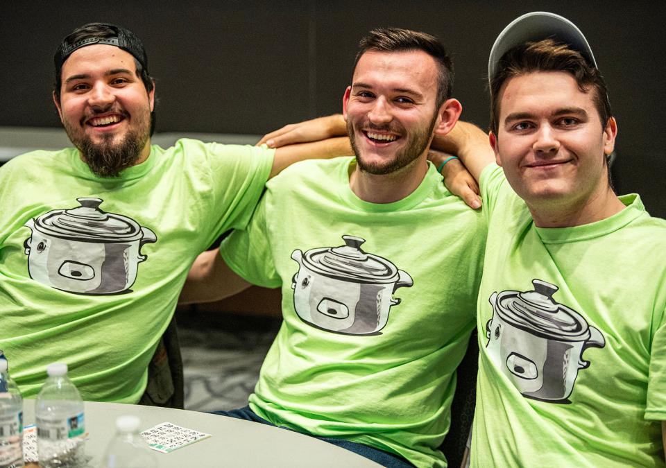 Three students wearing crockpot T-shirts at Bingo Night.