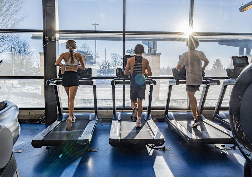 Three students running on treadmills