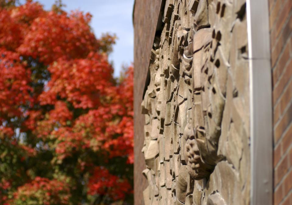 The sculpture named Indiana Landscape is displayed on the building's outside wall of Neff Hall.