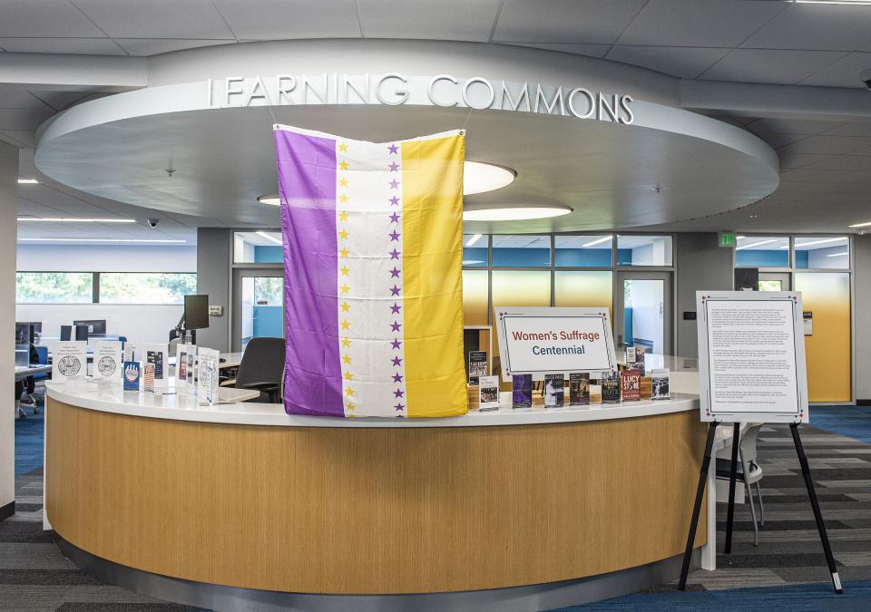 A replica of the Suffrage Victory Flag on display on the second floor of the Helmke Library at Purdue Fort Wayne.