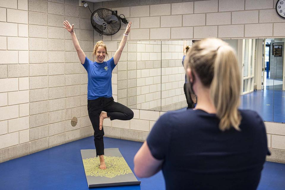 Employee health coach Lindsay Bloom leads a yoga class