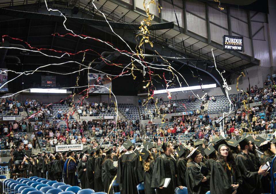 Joy and streamers fill the air at Memorial Coliseum during the most recent commencement ceremony for both universities.