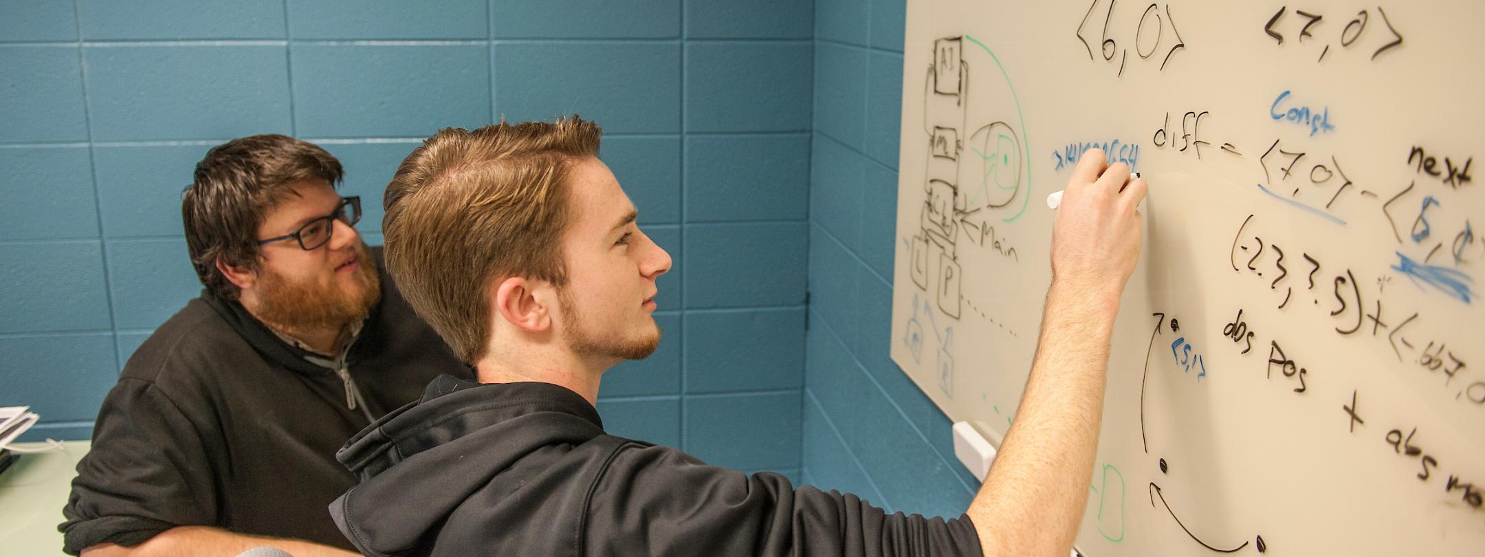 Students doing work on a whiteboard