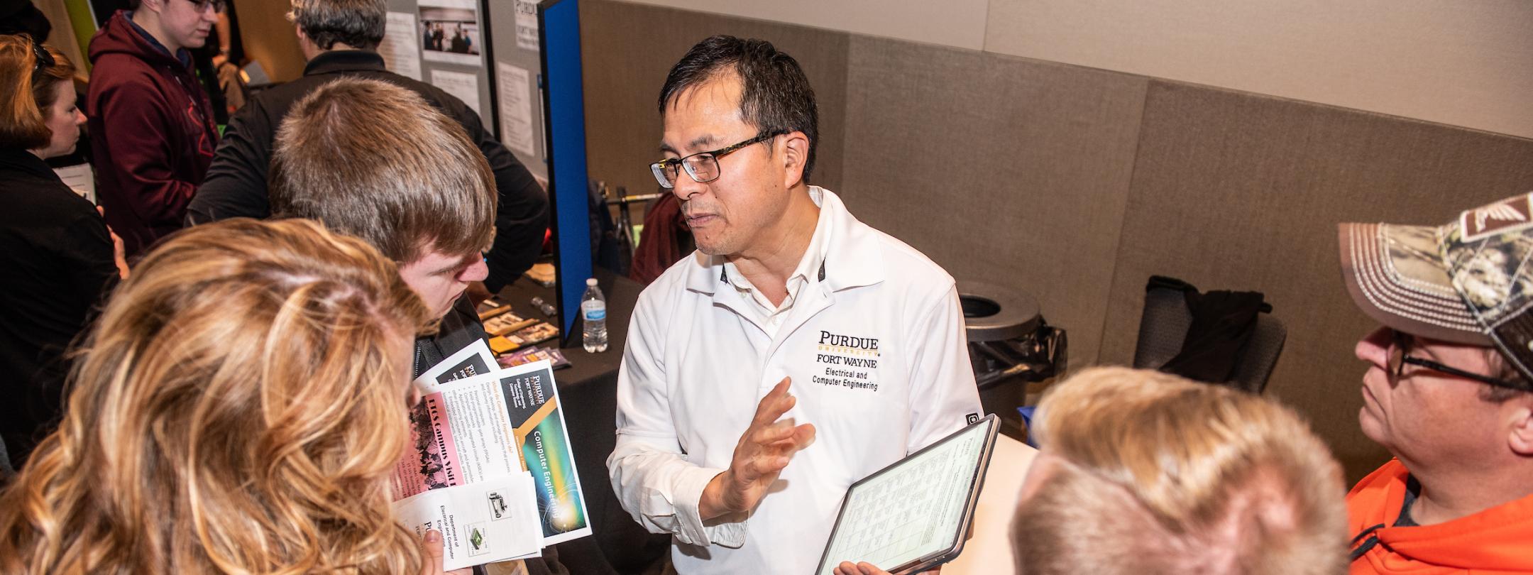 Faculty showing materials to students