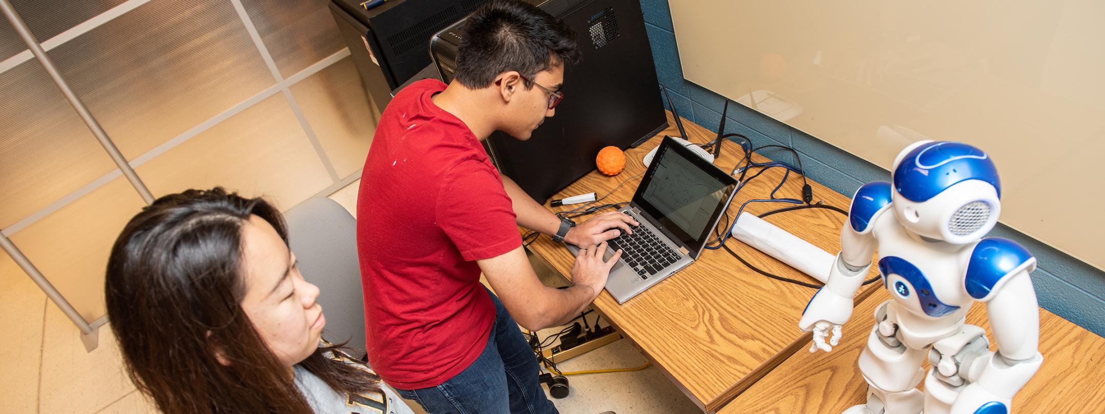 Students programming a robot