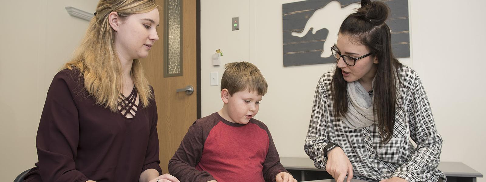 Students working with child