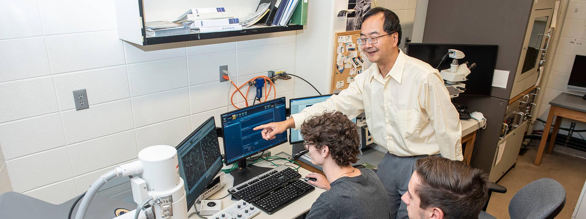 Dong Chen instructs students in the SEM Lab