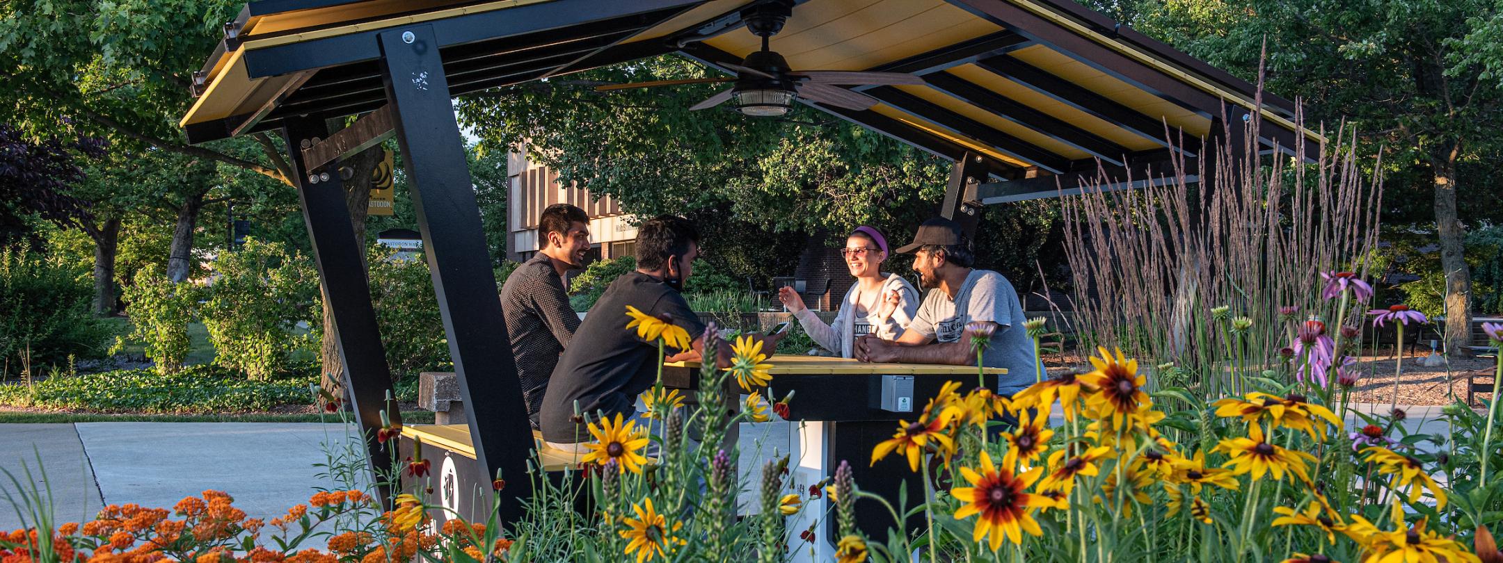 Students sitting in the solar hut