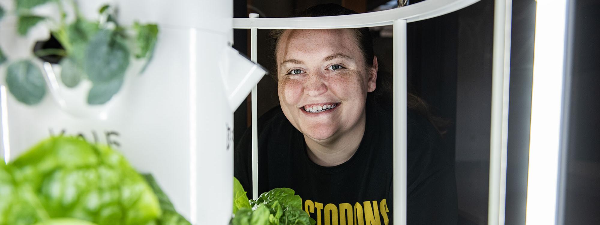 Rachel Hendryx is behind a hydroponic garden tower