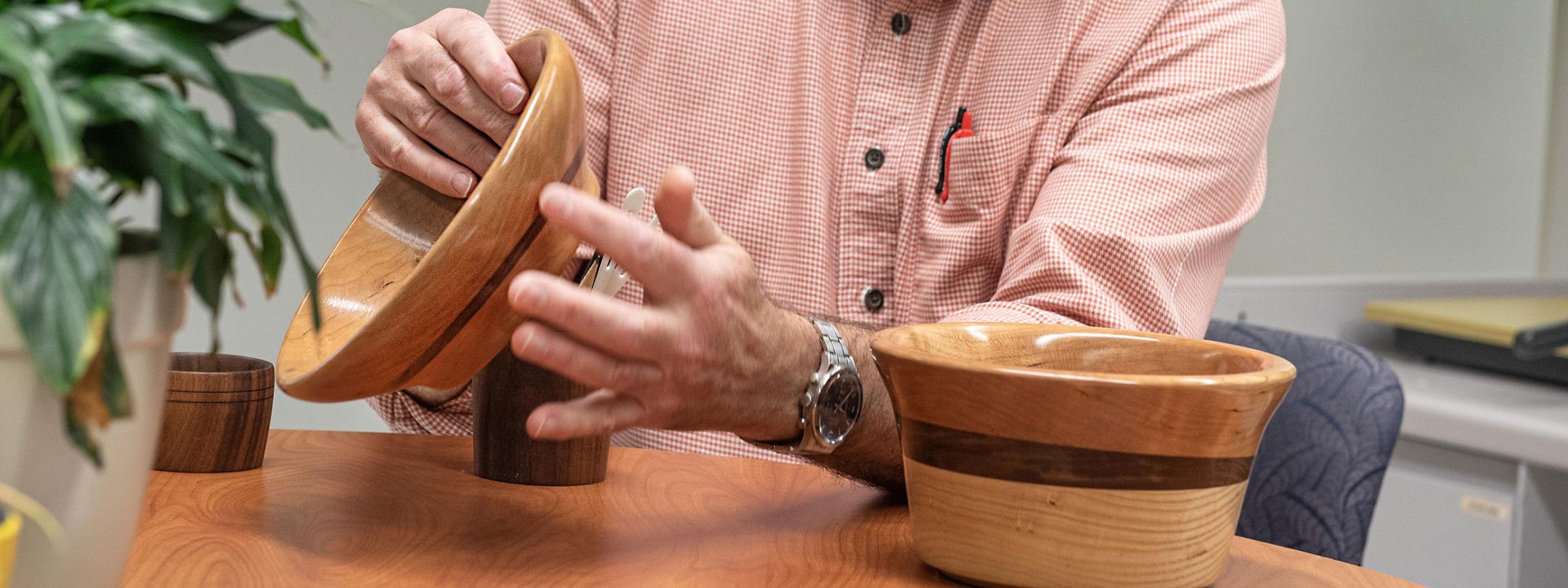 Barry Dupen displays some of the bowls he created.