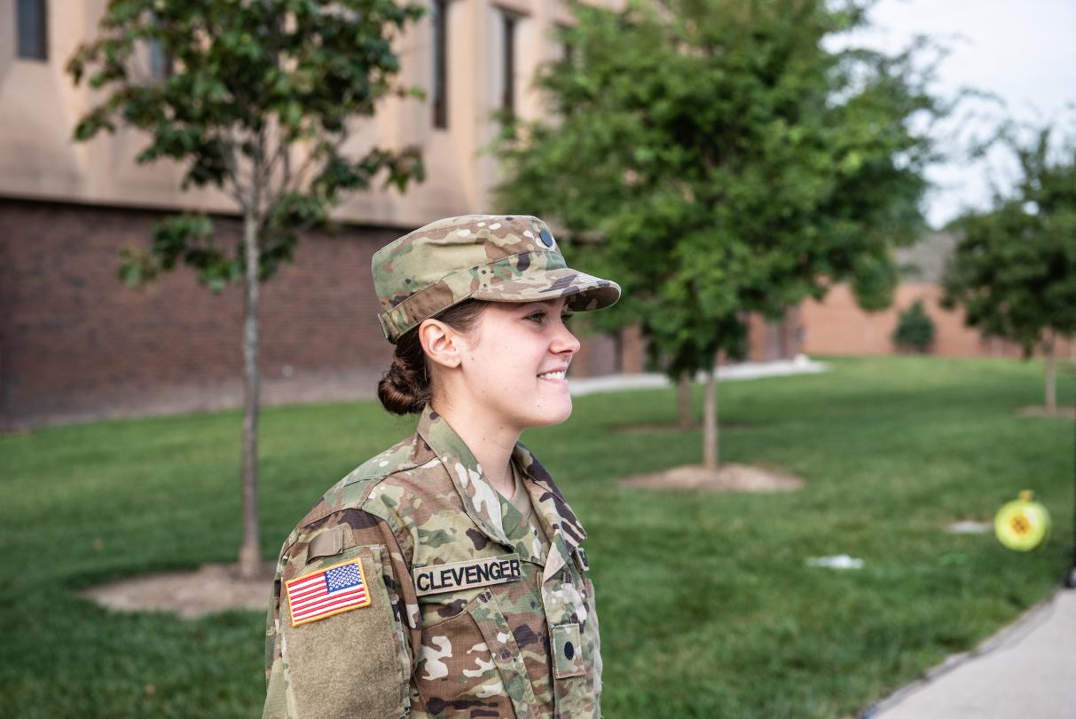 Woman in ROTC uniform on campus.