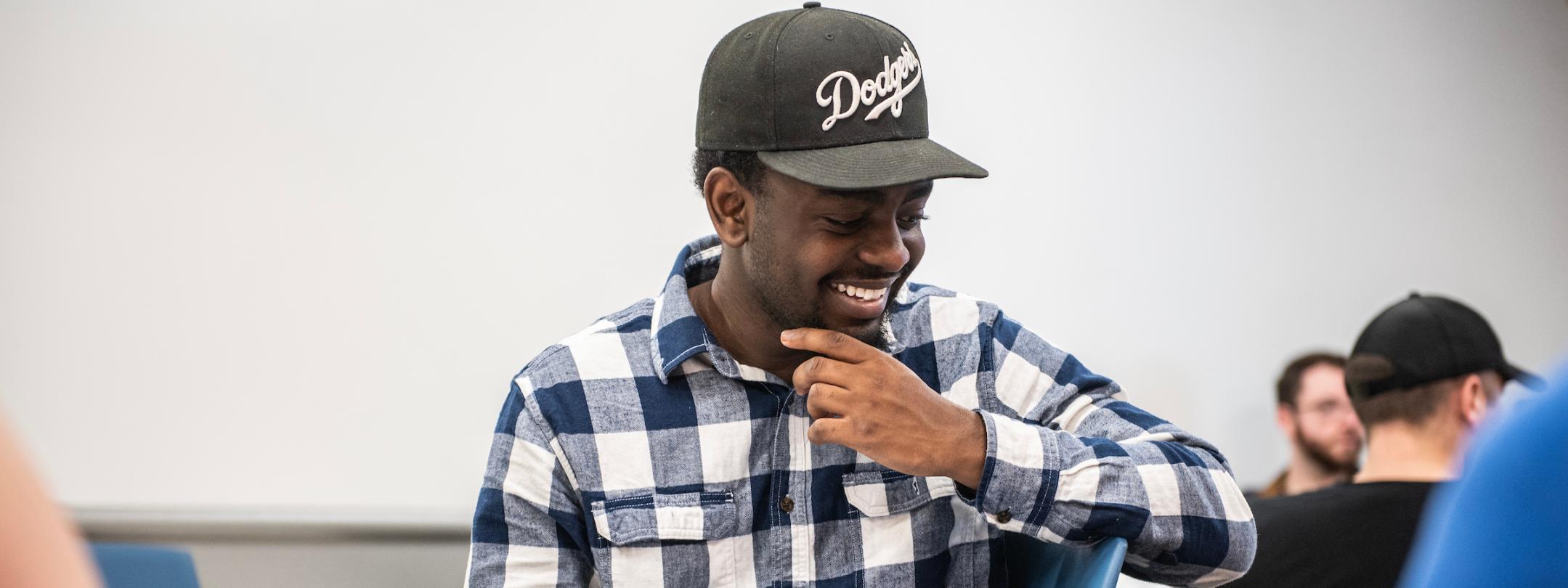 Student smiling in history class.