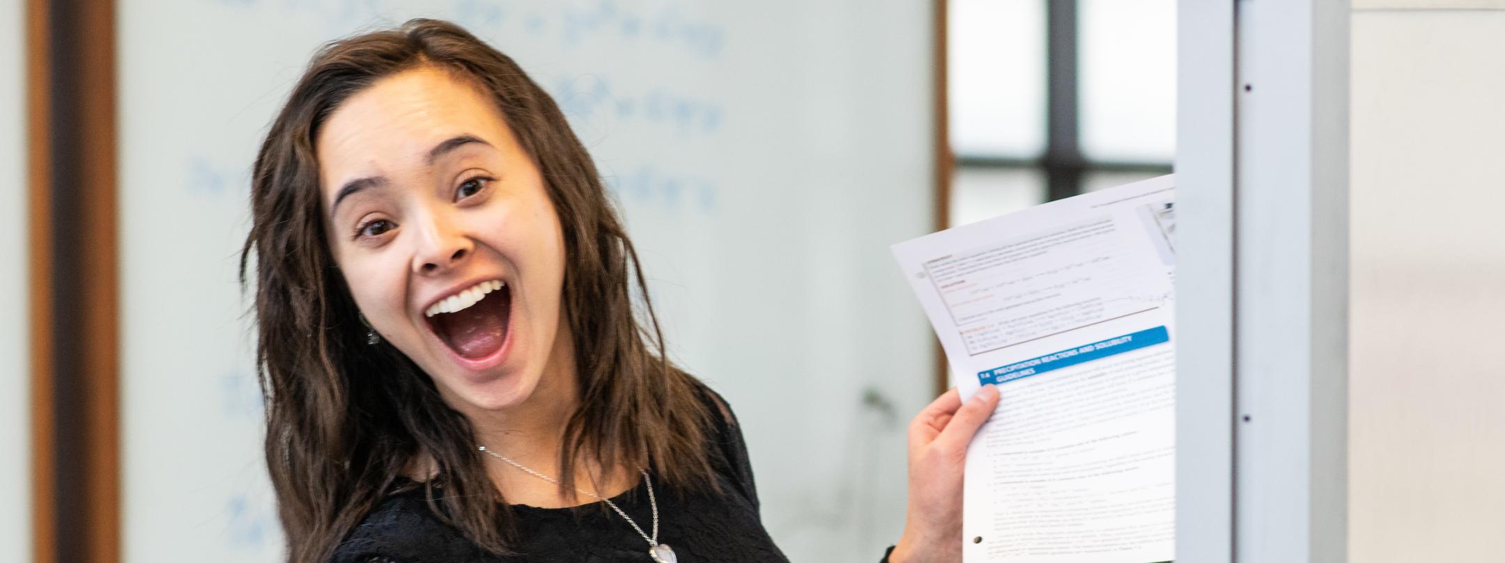 Student smiles for the camera while studying.