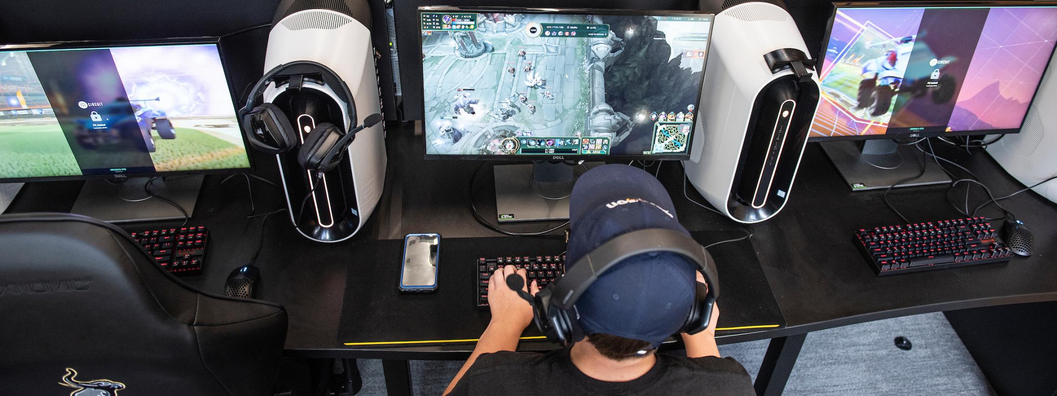 Student playing a video game in the esports lab.